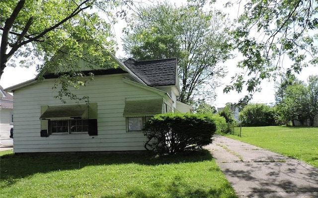 305 Porter St, Danville, IL 61832 - view of side of property featuring a lawn, roof with shingles, and concrete driveway