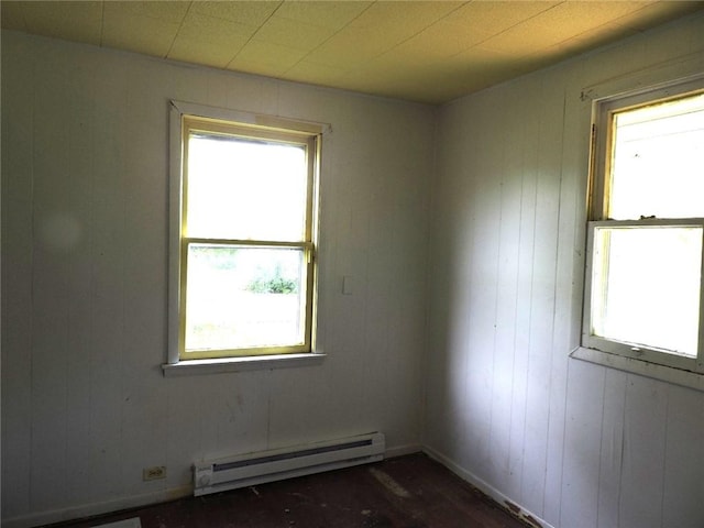305 Porter St, Danville, IL 61832 - unfurnished room featuring baseboard heating, healthy amount of natural light, wooden walls, and dark wood-style flooring