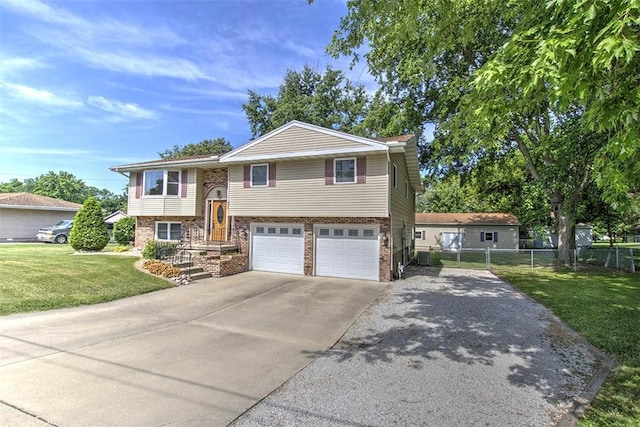 935 Woodland Dr, Mt Zion, IL 62549 - raised ranch with concrete driveway, an attached garage, and brick siding