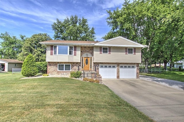 935 Woodland Dr, Mt Zion, IL 62549 - split foyer home with an attached garage, brick siding, and concrete driveway