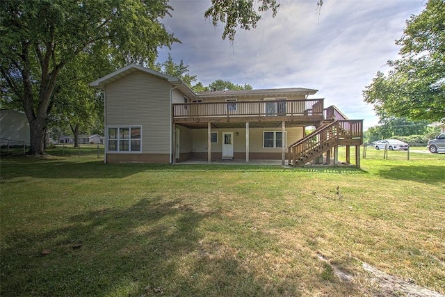 935 Woodland Dr, Mt Zion, IL 62549 - back of property with a deck, stairway, and a lawn