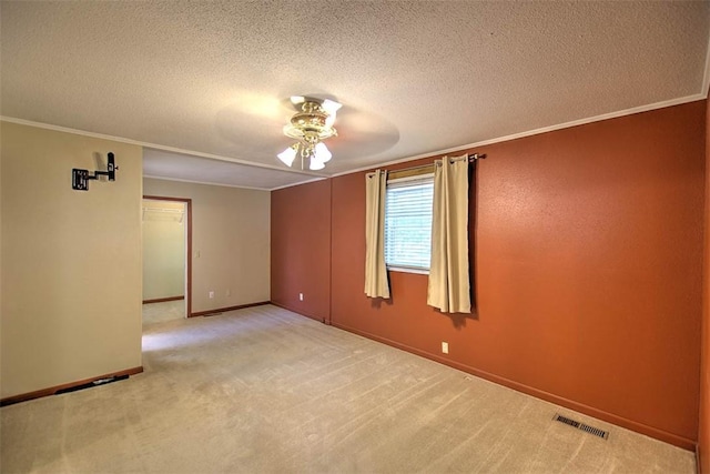 935 Woodland Dr, Mt Zion, IL 62549 - empty room featuring ceiling fan, a textured ceiling, crown molding, and carpet flooring