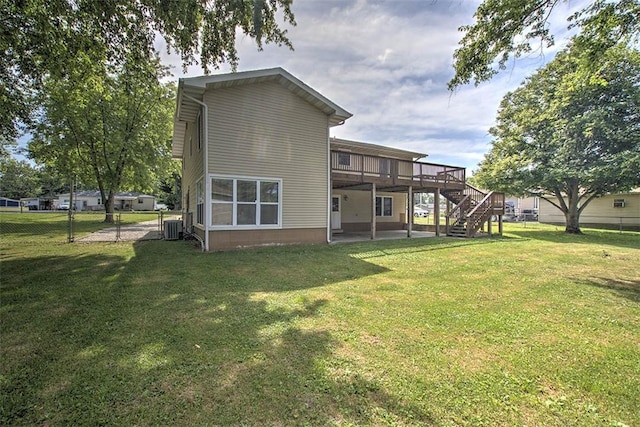 935 Woodland Dr, Mt Zion, IL 62549 - back of house featuring stairs, a wooden deck, and a patio area