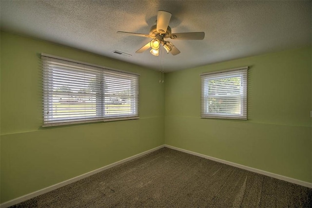 935 Woodland Dr, Mt Zion, IL 62549 - carpeted spare room with a textured ceiling and a ceiling fan