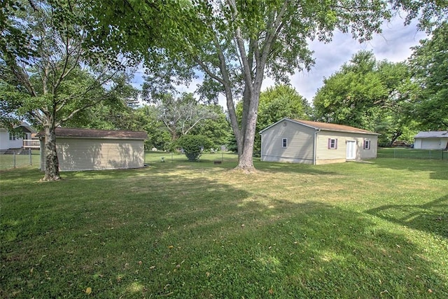 935 Woodland Dr, Mt Zion, IL 62549 - view of yard featuring an outbuilding and view of wooded area