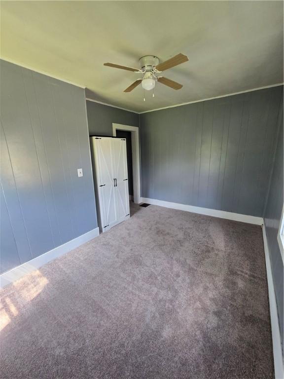 708 E Washington St, Clinton, IL 61727 - carpeted spare room with a ceiling fan and baseboards