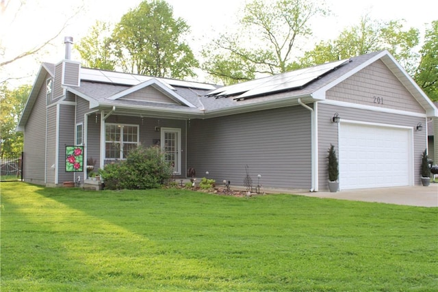 view of front of house with solar panels, a garage, a front yard, and a chimney
