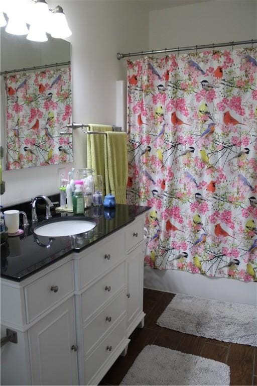 bathroom featuring vanity, shower / tub combo, and wood finished floors