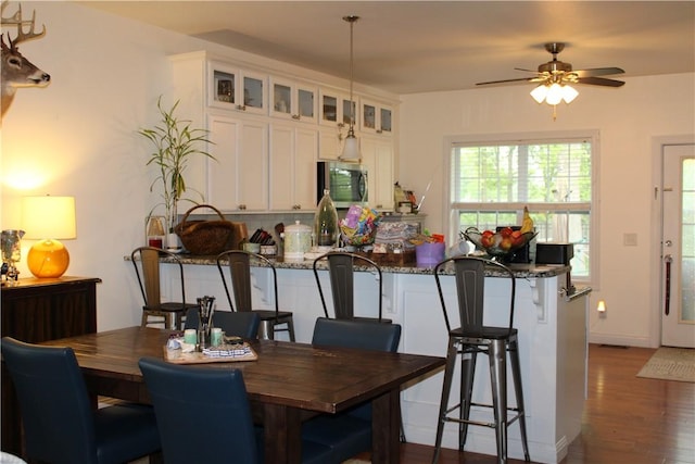 dining room featuring wood finished floors and a ceiling fan