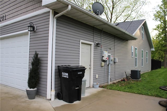 view of home's exterior with central AC and a yard