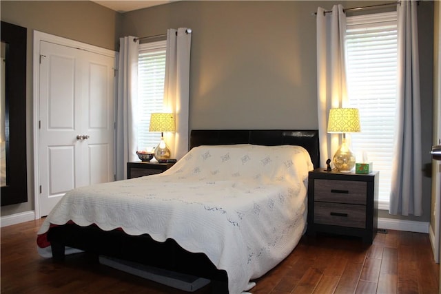 bedroom featuring wood finished floors and baseboards