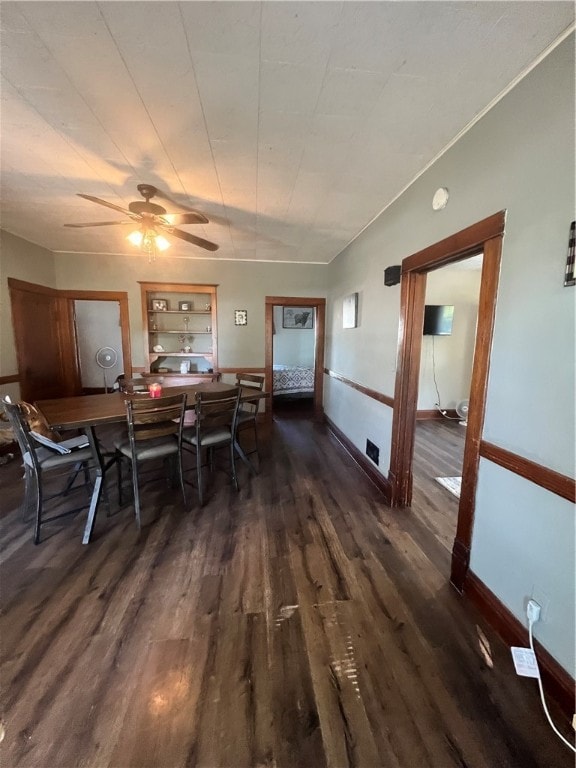 dining room featuring ceiling fan and dark wood-type flooring