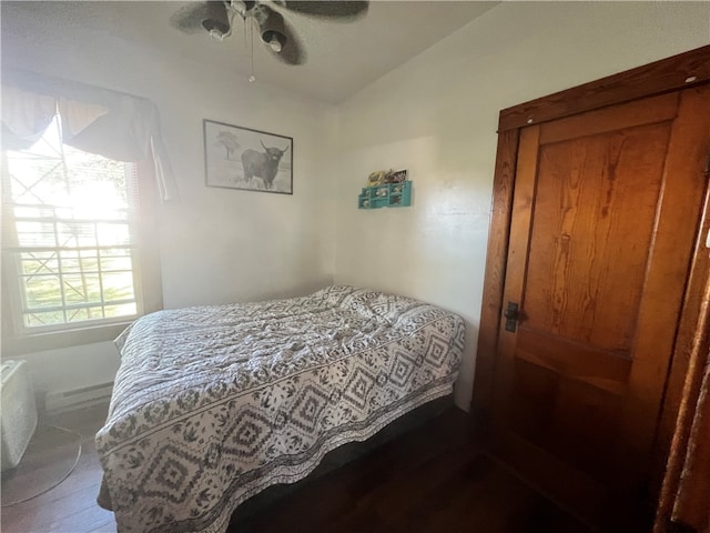 bedroom featuring hardwood / wood-style flooring, ceiling fan, and vaulted ceiling