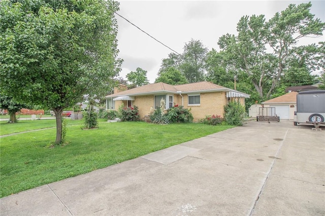 820 Oklahoma Ave, Mattoon, IL 61938 - ranch-style house with an outdoor structure, a front yard, and brick siding