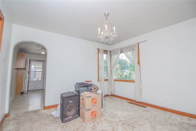 820 Oklahoma Ave, Mattoon, IL 61938 - spare room featuring arched walkways and a chandelier
