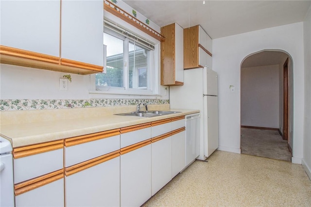 820 Oklahoma Ave, Mattoon, IL 61938 - kitchen featuring arched walkways, dishwasher, light countertops, and white cabinets