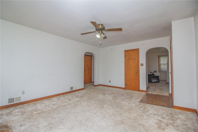 820 Oklahoma Ave, Mattoon, IL 61938 - unfurnished room featuring arched walkways, a ceiling fan, and light carpet