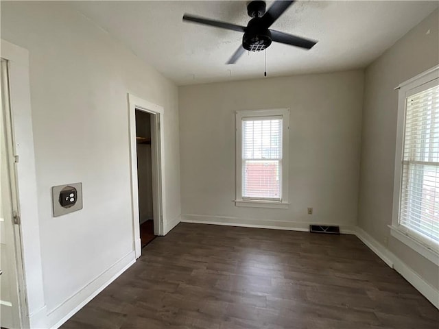 601 S Maple St, Effingham, IL 62401 - unfurnished bedroom featuring multiple windows, dark wood-style floors, and baseboards
