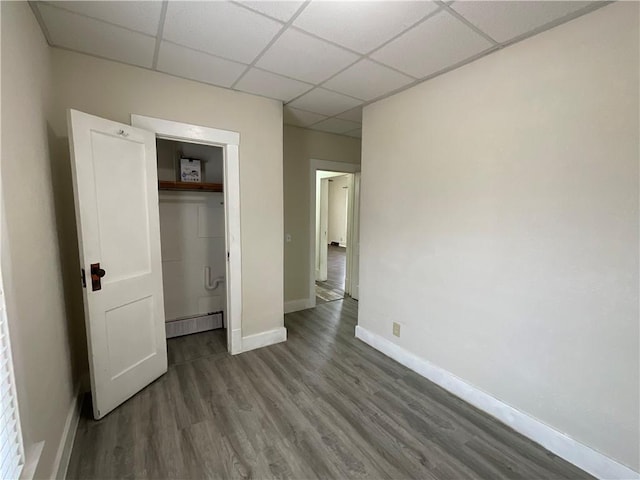 601 S Maple St, Effingham, IL 62401 - unfurnished bedroom with a drop ceiling, wood finished floors, baseboards, and a closet