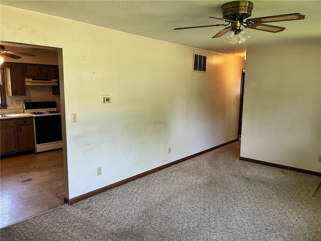 300 W Alabama Ave, Casey, IL 62420 - carpeted empty room with ceiling fan, baseboards, and a sink