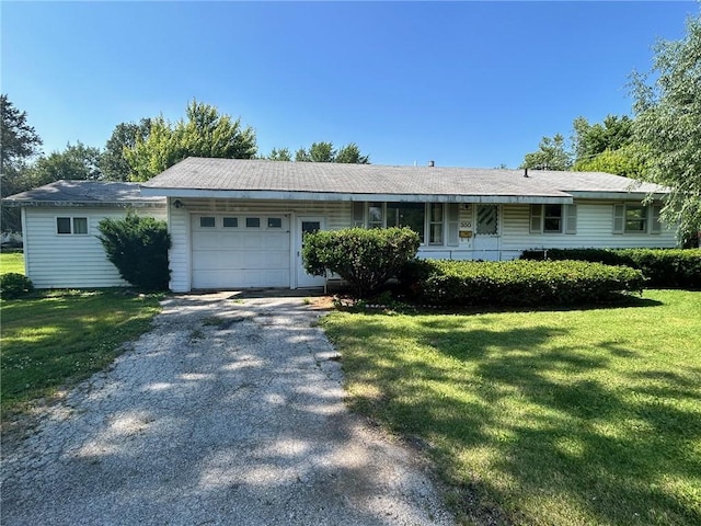300 W Alabama Ave, Casey, IL 62420 - ranch-style house with an attached garage, driveway, and a front yard
