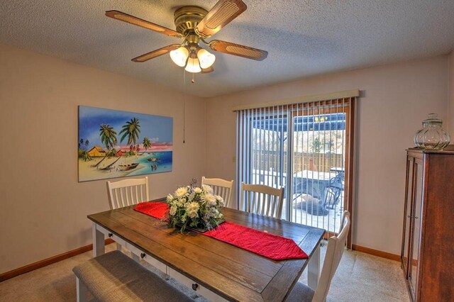 993 Cedar Hill Dr, Decatur, IL 62521 - dining area featuring light carpet, ceiling fan, baseboards, and a textured ceiling