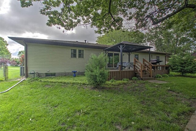 993 Cedar Hill Dr, Decatur, IL 62521 - back of property with a wooden deck and a gate