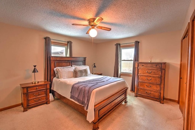 993 Cedar Hill Dr, Decatur, IL 62521 - bedroom with light colored carpet, a textured ceiling, ceiling fan, and baseboards