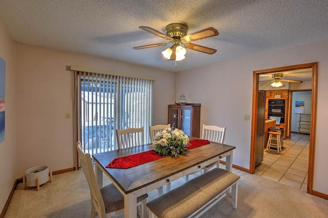 993 Cedar Hill Dr, Decatur, IL 62521 - dining space featuring ceiling fan, light colored carpet, baseboards, a textured ceiling, and light tile patterned floors