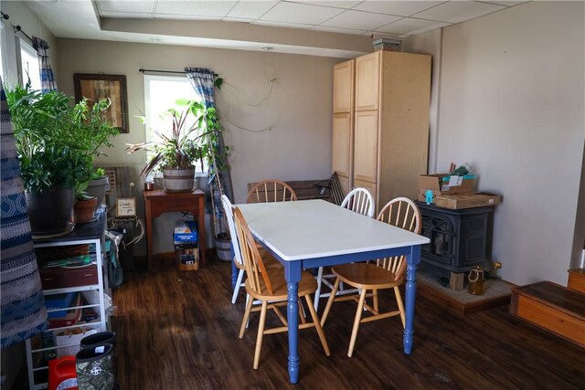 1741 Murray Clark Rd, Danville, IL 61832 - dining area with dark wood-style floors, a wood stove, and a paneled ceiling