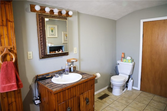 1741 Murray Clark Rd, Danville, IL 61832 - half bathroom featuring baseboards, toilet, lofted ceiling, tile patterned floors, and vanity