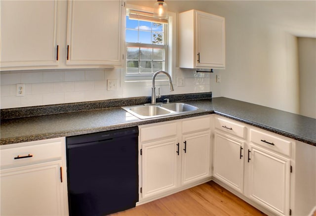 11 Copperfield Ln, Charleston, IL 61920 - kitchen with black dishwasher, dark countertops, white cabinets, light wood-style floors, and backsplash
