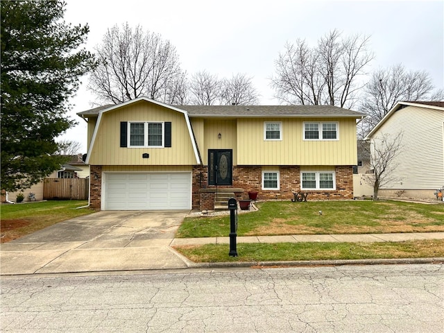 bi-level home with a garage and a front lawn