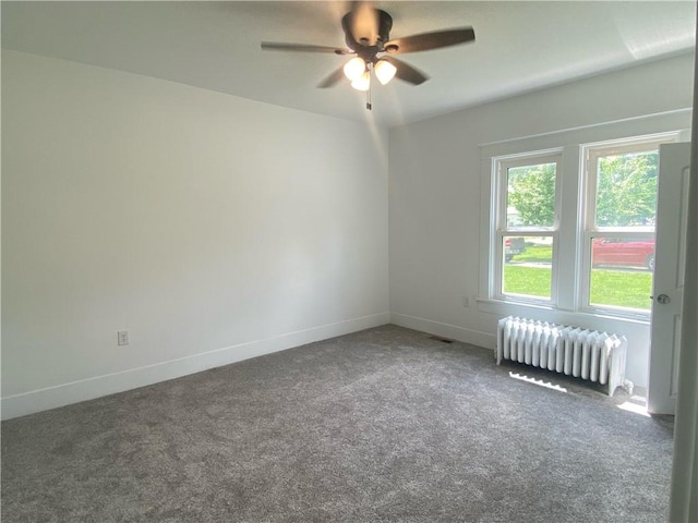 101 S Sheridan St, Pana, IL 62557 - carpeted empty room featuring radiator heating unit, ceiling fan, and baseboards
