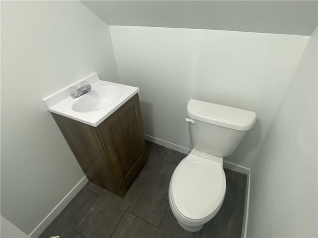101 S Sheridan St, Pana, IL 62557 - bathroom featuring vanity, wood finished floors, toilet, and baseboards