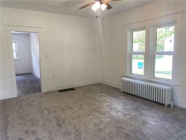 101 S Sheridan St, Pana, IL 62557 - unfurnished room with radiator heating unit, carpet floors, and healthy amount of natural light