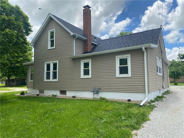 101 S Sheridan St, Pana, IL 62557 - back of property featuring a chimney, a lawn, and roof with shingles