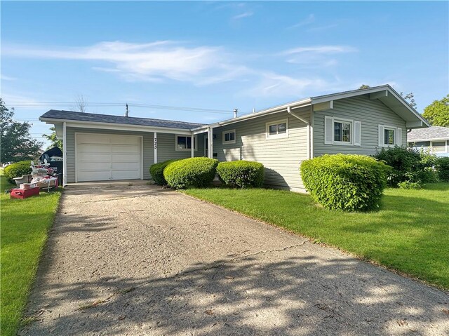 723 Kenton Dr, Charleston, IL 61920 - ranch-style house with an attached garage, a front yard, and asphalt driveway