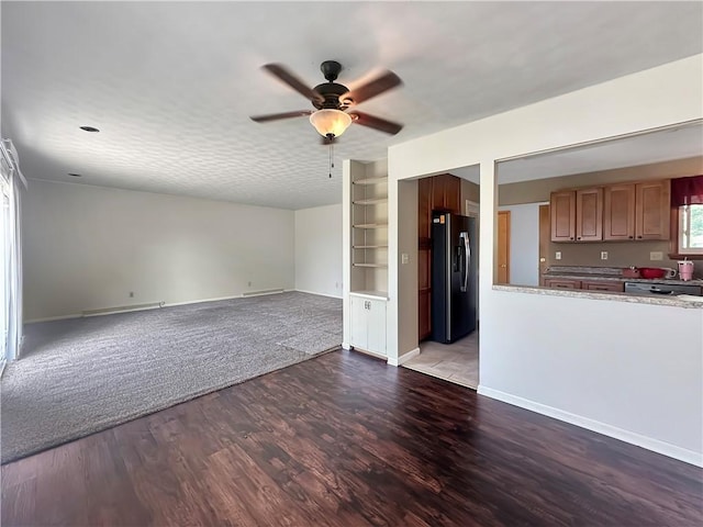 723 Kenton Dr, Charleston, IL 61920 - unfurnished living room featuring a ceiling fan, baseboard heating, wood finished floors, and built in features