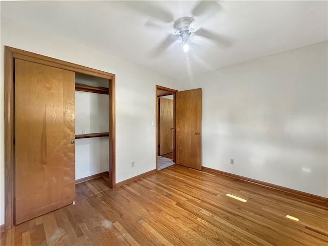 723 Kenton Dr, Charleston, IL 61920 - unfurnished bedroom featuring light wood-style flooring, a closet, and a ceiling fan