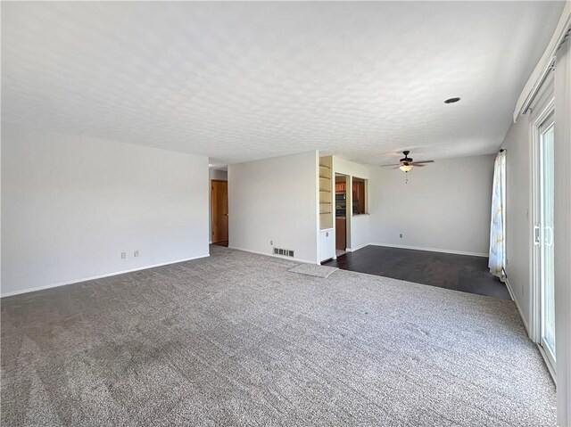 723 Kenton Dr, Charleston, IL 61920 - spare room with dark carpet and a ceiling fan