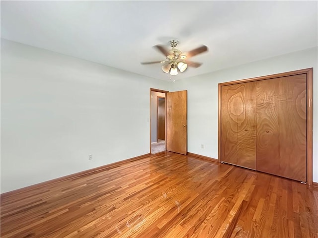 723 Kenton Dr, Charleston, IL 61920 - unfurnished bedroom featuring light wood finished floors, a closet, and a ceiling fan