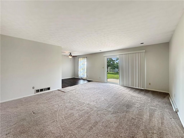723 Kenton Dr, Charleston, IL 61920 - spare room with dark carpet, a baseboard heating unit, and ceiling fan
