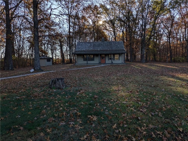 21491 N 1150th St, Marshall, IL 62441 - view of front of home featuring an outbuilding, a chimney, and covered porch