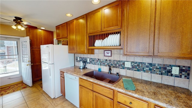 kitchen with white appliances, light tile patterned floors, ceiling fan, a sink, and tasteful backsplash