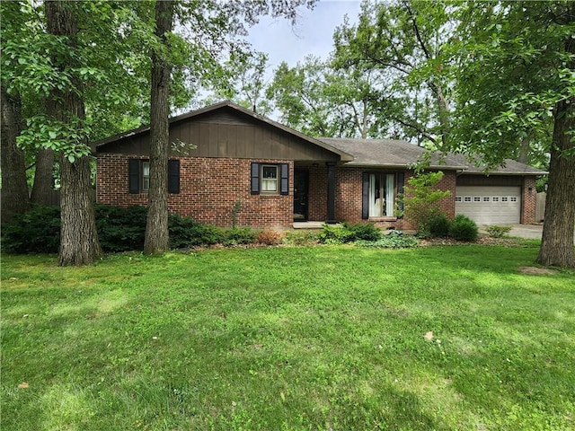 1101 Robinwood Dr, Robinson, IL 62454 - single story home featuring an attached garage, brick siding, a front lawn, and driveway