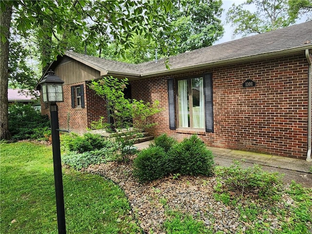 1101 Robinwood Dr, Robinson, IL 62454 - view of side of property with brick siding, roof with shingles, and a yard