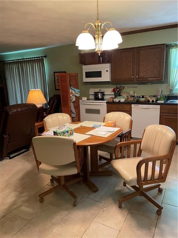 1101 Robinwood Dr, Robinson, IL 62454 - dining room featuring a chandelier, light tile patterned floors, and crown molding