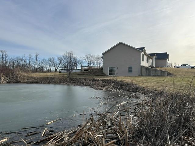 view of property exterior with a water view