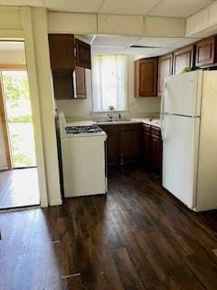 702 Chandler St, Danville, IL 61832 - kitchen featuring white appliances, light countertops, and dark wood finished floors